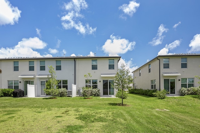 rear view of property featuring a yard