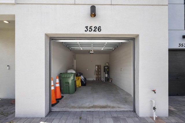 garage with a garage door opener and water heater