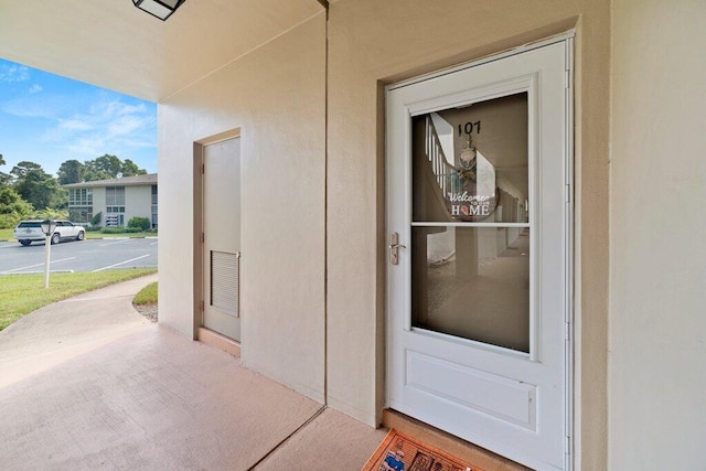 27 Lake Vista Trl Unit 107, Port Saint Lucie, FL 34952 - view of exterior entry featuring stucco siding