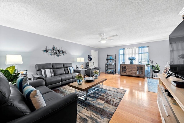 27 Lake Vista Trl Unit 107, Port Saint Lucie, FL 34952 - living area featuring a ceiling fan, light wood finished floors, and a textured ceiling