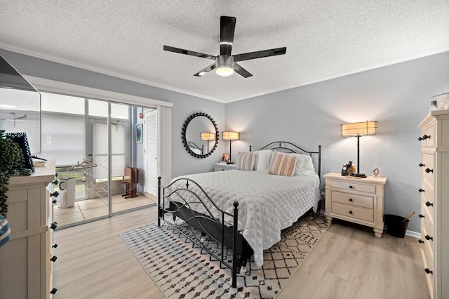 27 Lake Vista Trl Unit 107, Port Saint Lucie, FL 34952 - bedroom featuring light wood finished floors, crown molding, a textured ceiling, and a ceiling fan