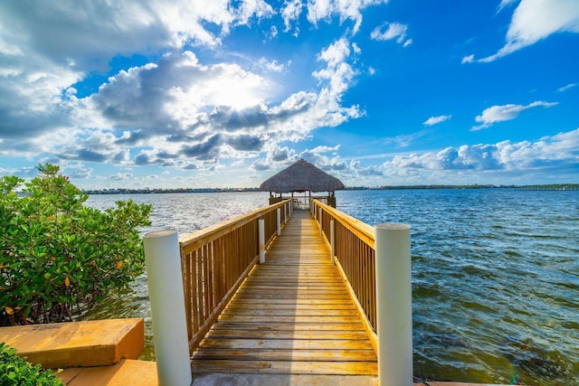 view of dock with a gazebo and a water view