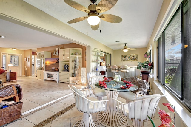 tiled dining area featuring ceiling fan