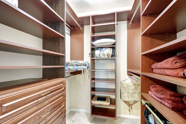 spacious closet featuring light tile patterned floors