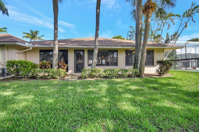 ranch-style house featuring a lanai and a front lawn