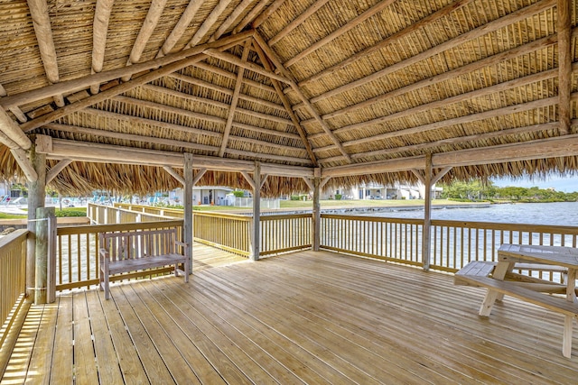 wooden terrace featuring a gazebo and a water view