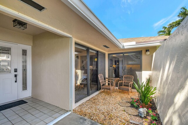 property entrance featuring a patio area