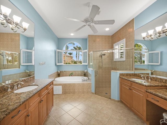 bathroom with tile patterned flooring, a wealth of natural light, vanity, and plus walk in shower