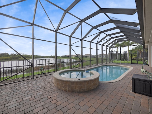 view of swimming pool with a water view, glass enclosure, an in ground hot tub, and a patio area