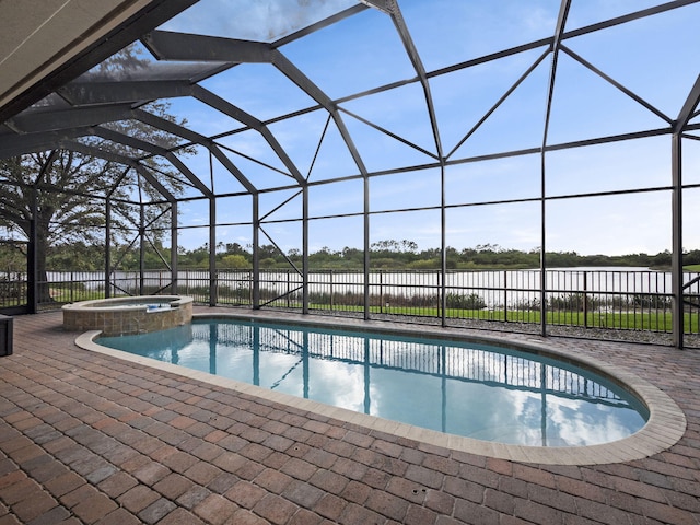 view of swimming pool with glass enclosure, a patio, and an in ground hot tub