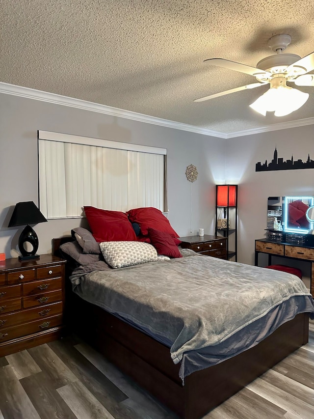 bedroom with ornamental molding, wood-type flooring, a textured ceiling, and ceiling fan