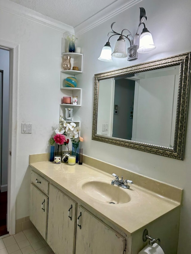 bathroom featuring ornamental molding, vanity, a textured ceiling, and tile patterned floors