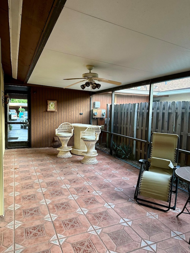 unfurnished sunroom featuring ceiling fan