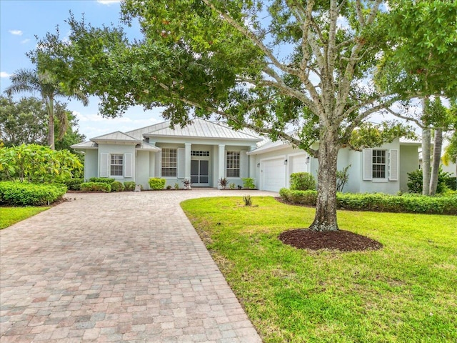 view of front of home with a front yard and a garage