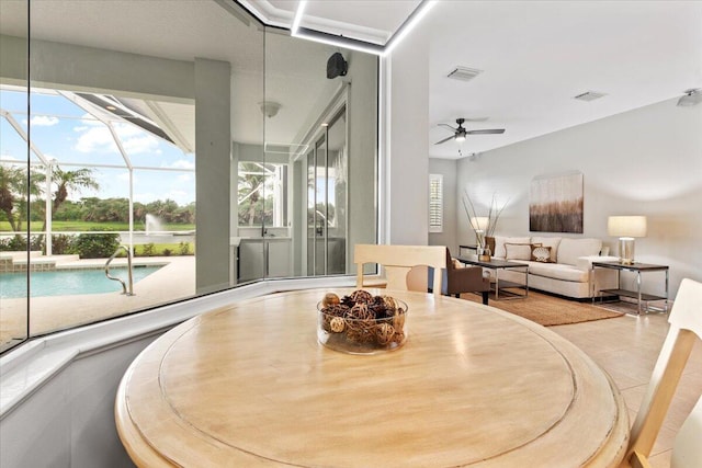 dining room featuring ceiling fan and light tile patterned floors