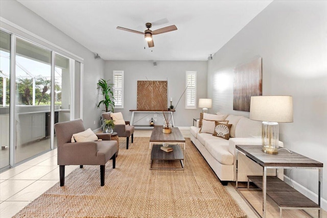 living room with ceiling fan and light tile patterned flooring