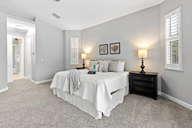 carpeted bedroom with ensuite bath