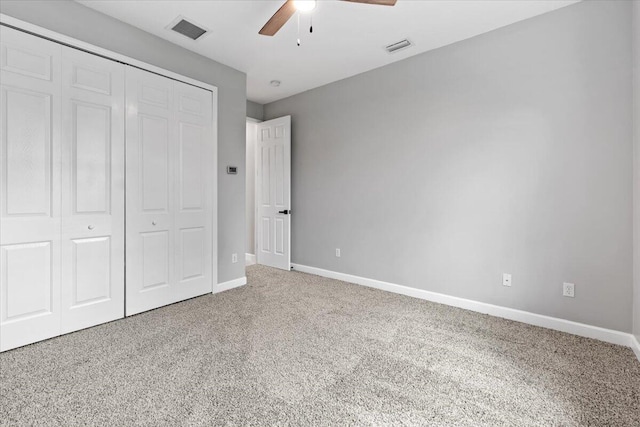 unfurnished bedroom with carpet, a closet, and ceiling fan