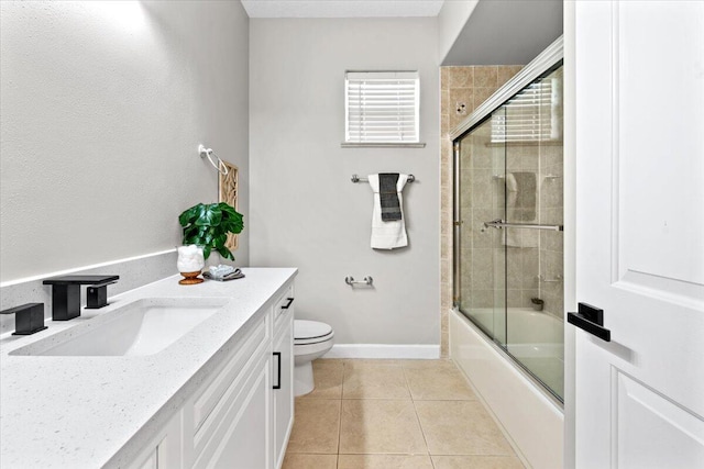 full bathroom with tile patterned floors, shower / bath combination with glass door, vanity, and toilet