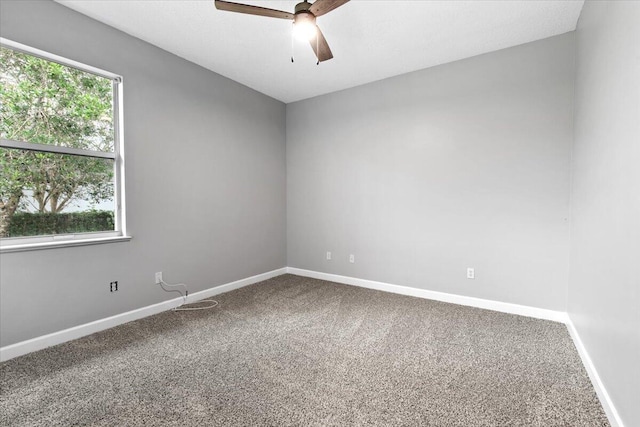 unfurnished room with carpet flooring, ceiling fan, and plenty of natural light