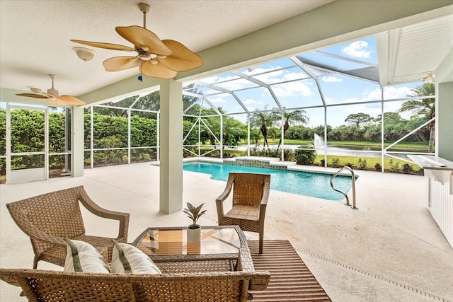 view of pool featuring glass enclosure and a patio