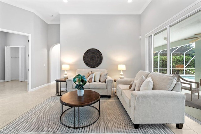 living room featuring a healthy amount of sunlight, light tile patterned flooring, and ornamental molding