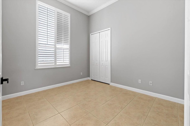 tiled spare room featuring crown molding