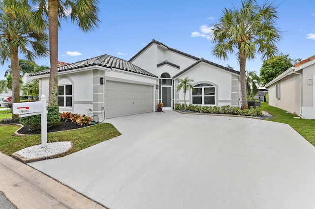 mediterranean / spanish-style house with a garage