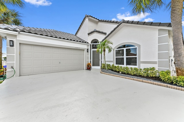 mediterranean / spanish-style home featuring a garage