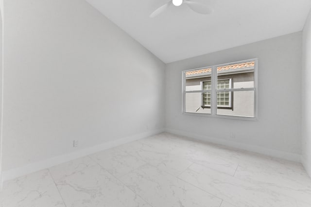 spare room featuring ceiling fan and vaulted ceiling