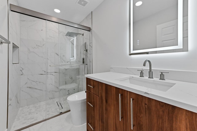 bathroom with vanity, toilet, and an enclosed shower