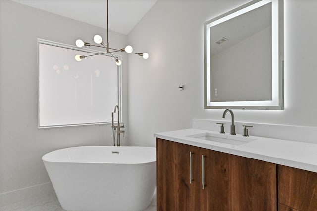 bathroom featuring a bathtub, vanity, and a chandelier