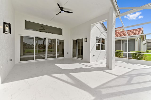 unfurnished sunroom with ceiling fan and plenty of natural light