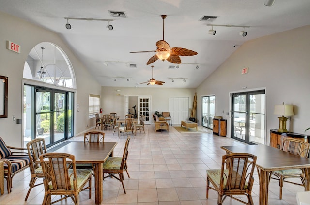 dining space with french doors, rail lighting, ceiling fan, and light tile patterned flooring