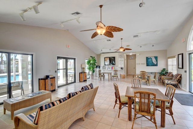 dining area featuring track lighting, plenty of natural light, ceiling fan, and light tile patterned floors