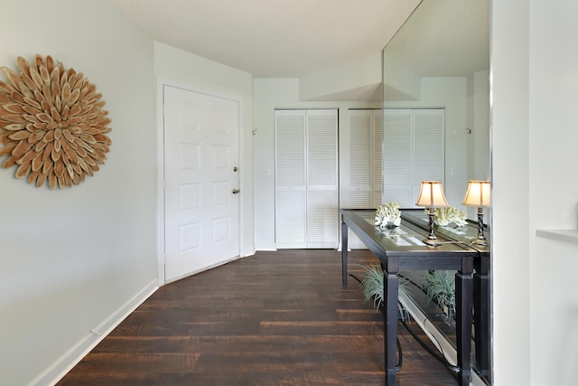 corridor with wood finished floors and baseboards