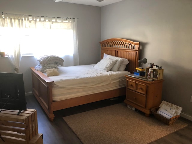 bedroom with dark hardwood / wood-style flooring