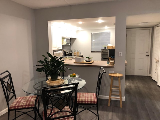 dining room with dark hardwood / wood-style floors