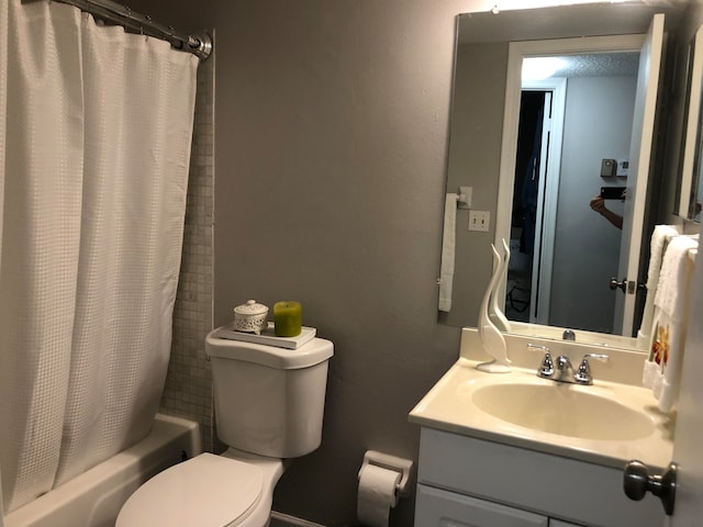 full bathroom with toilet, vanity, and shower / bath combination with curtain