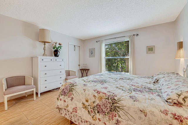 bedroom with a textured ceiling and a closet