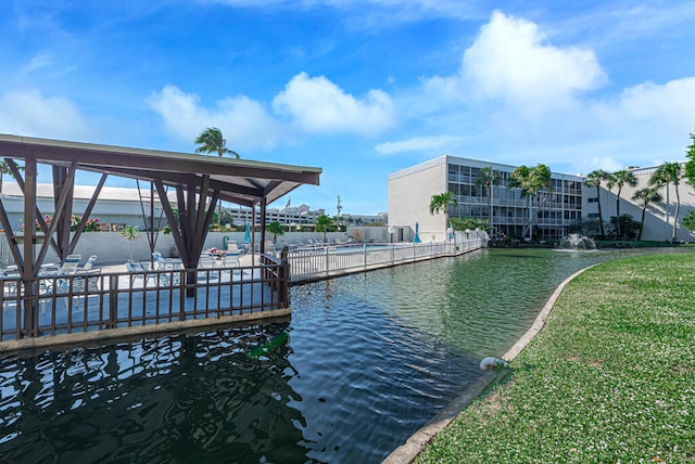 dock area featuring a lawn and a water view