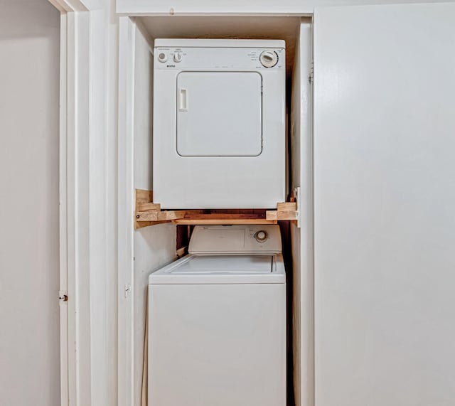 laundry area featuring stacked washer / drying machine