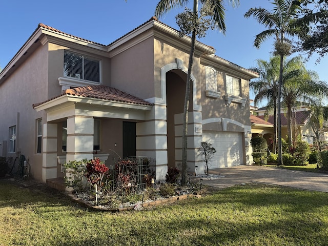 view of front of property with a front yard and a garage