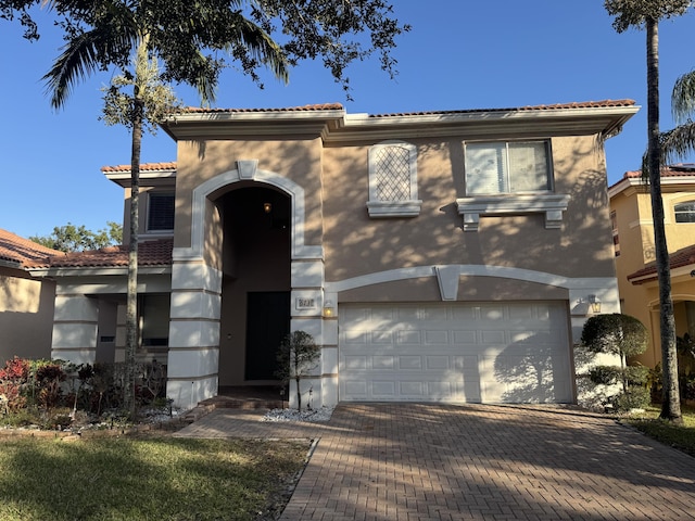 mediterranean / spanish-style home featuring a garage