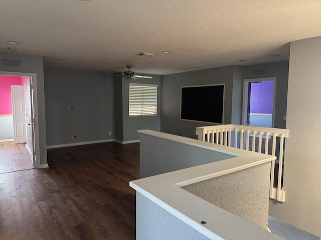 hall featuring dark hardwood / wood-style flooring and a textured ceiling