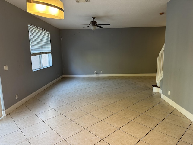 tiled empty room with ceiling fan