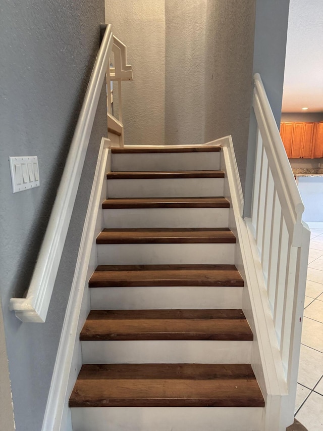 stairway featuring tile patterned floors