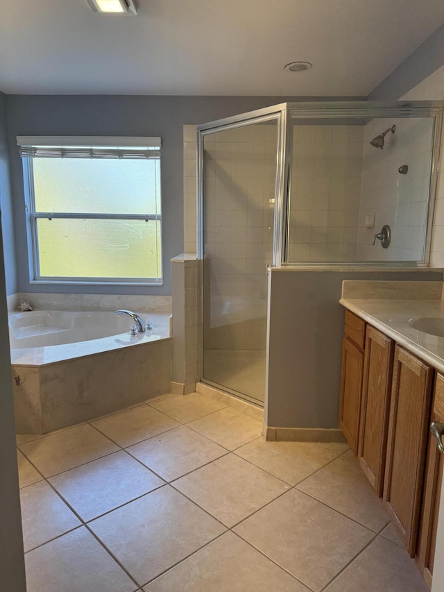 bathroom featuring vanity, plus walk in shower, and tile patterned floors