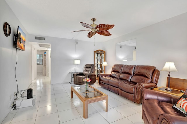 living room featuring light tile patterned floors and ceiling fan