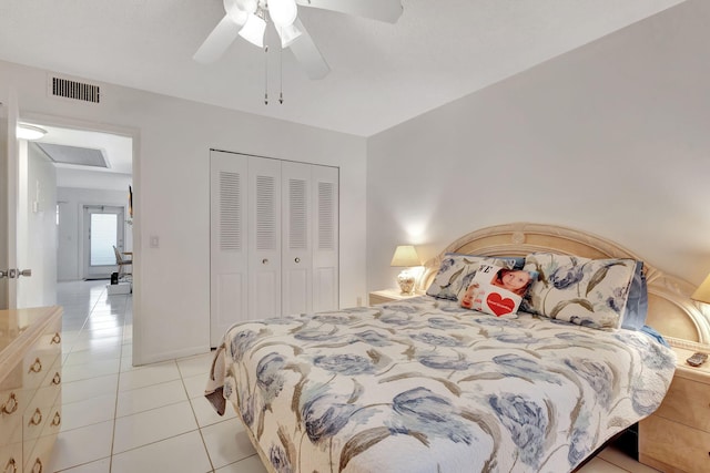 tiled bedroom with a closet and ceiling fan